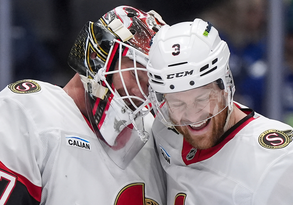 Ottawa Senators goalie James Reimer, left, and Nick Jensen celebrate after Ottawa defeated the Vancouver Canucks 2-0 during an NHL hockey game, in Vancouver, on Monday, March 9, 2026. (Darryl Dyck/The Canadian Press via AP)