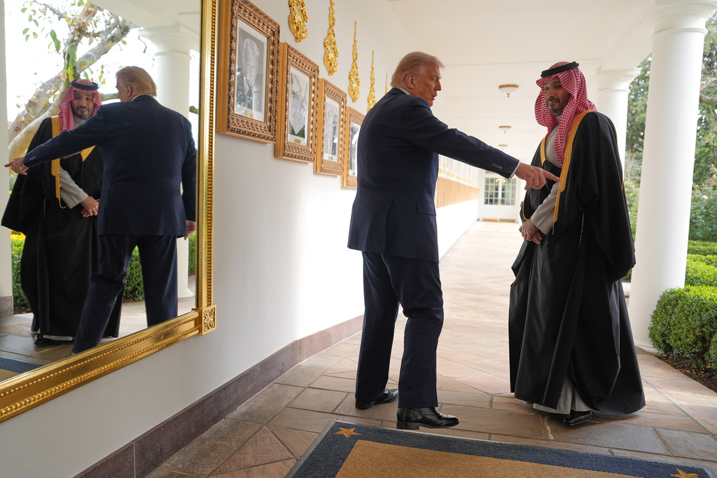 President Donald Trump and Saudi Arabia's Crown Prince Mohammed bin Salman walk along the Colonnade at the White House, Tuesday, Nov. 18, 2025, in Washington. (AP Photo/Evan Vucci)