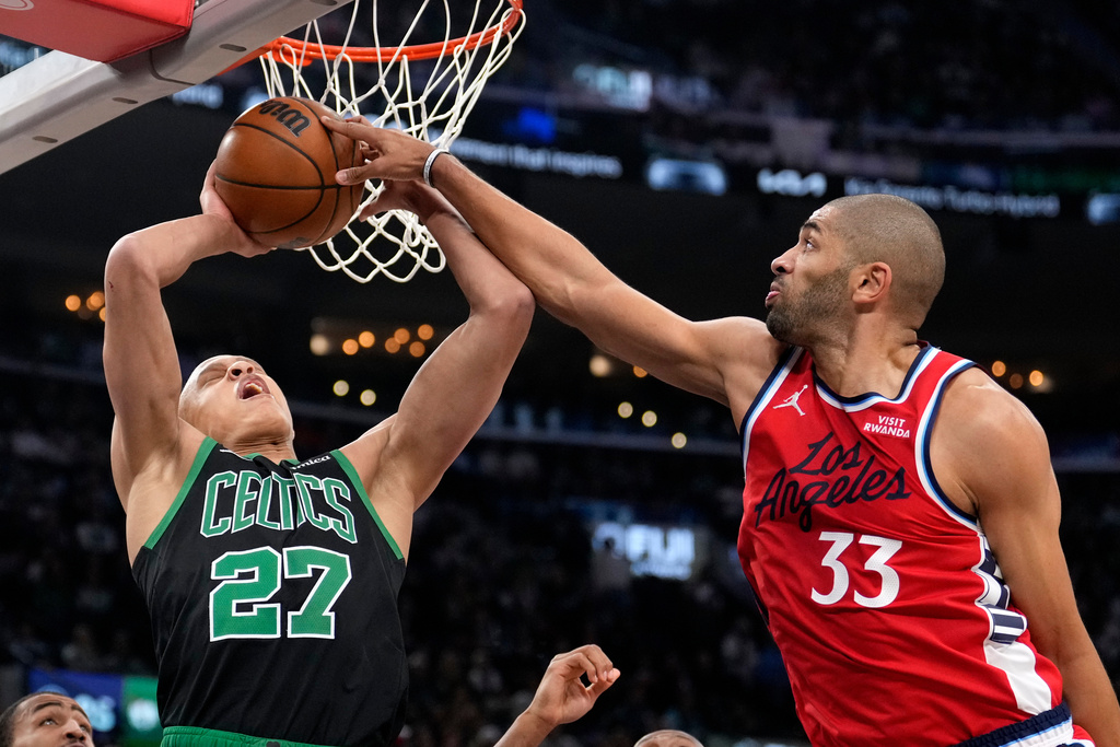 Boston Celtics guard Jordan Walsh, left, has his shot blocked by Los Angeles Clippers forward Nicolas Batum during the first half of an NBA basketball game Saturday, Jan. 3, 2026, in Inglewood, Calif. (AP Photo/Mark J. Terrill)