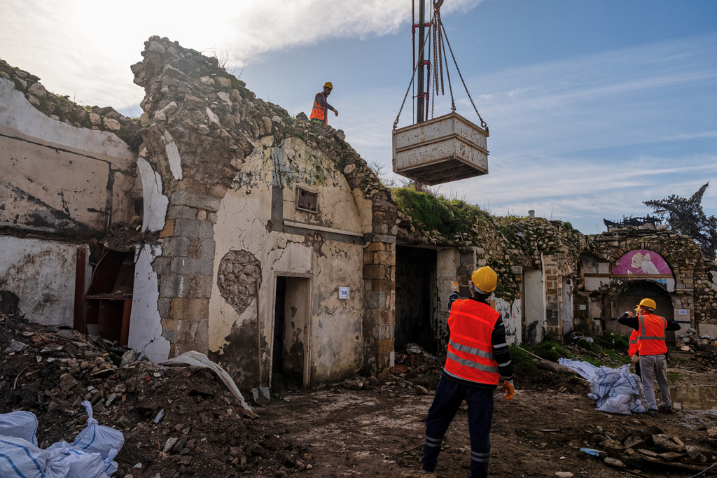 Workers clear rubble and salvage stones from the ruins of St. Paul's Greek Orthodox Church, damaged in the 2023 earthquake, in the city of Antakya, southern Turkey, Wednesday, Feb. 4, 2026. (AP Photo/Murat Kocabas)