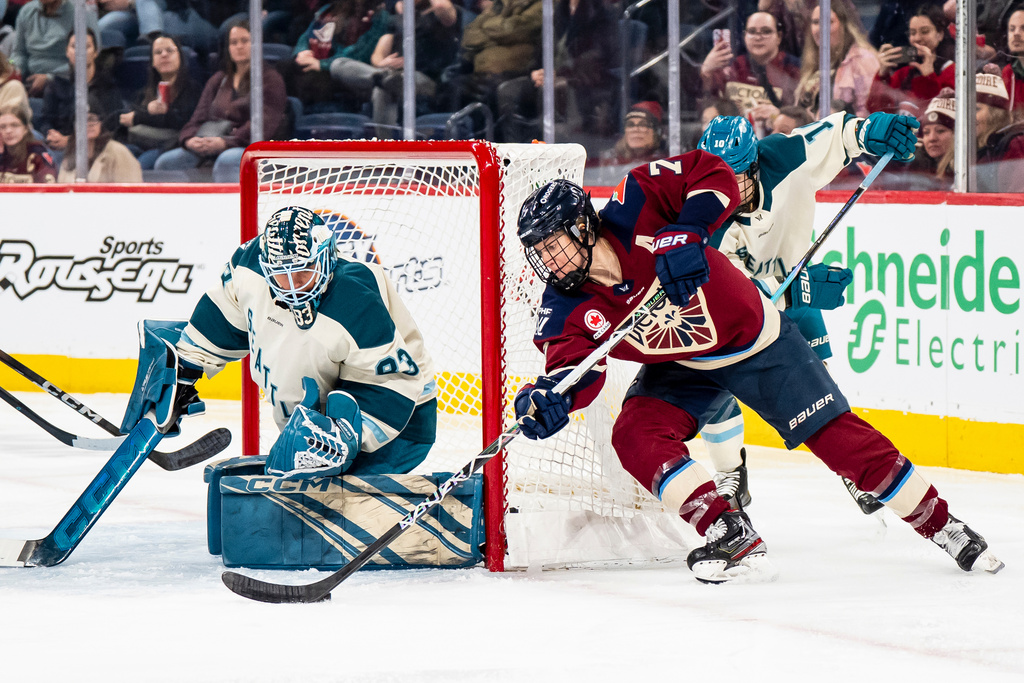 Montreal Victoire's Laura Stacey (7) skates around the net while goaltender Hannah Murphy (83) defends during second period PWHL hockey action in Laval, Que., on Thursday, March 19, 2026. (Christopher Katsarov/The Canadian Press via AP)