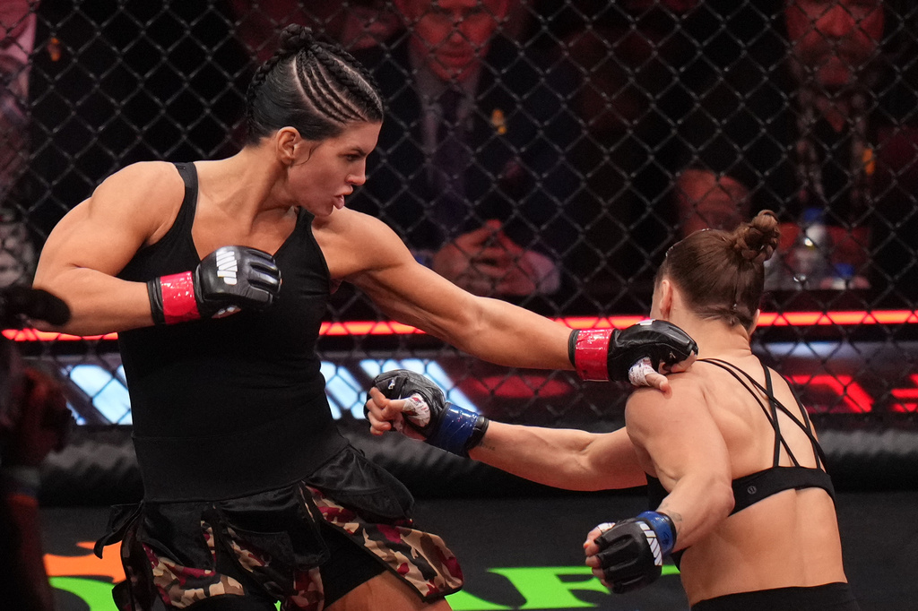 Gina Carano, of the United States, left, fights Ronda Rousey, of the United States, during their featherweight mixed martial arts fight Saturday, May 16, 2026, in Inglewood, Calif. (AP Photo/Jae C. Hong )
