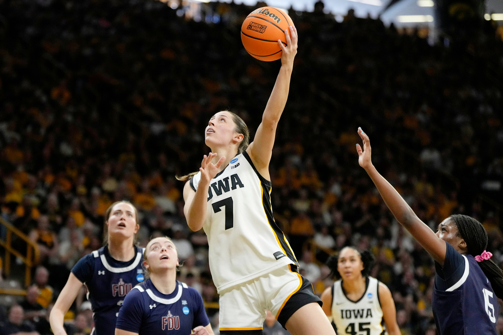 Iowa guard Addison Deal (7) drives to the basket over Fairleigh Dickinson forward Leah Crosby (15) during the first half in the first round of the NCAA college basketball tournament, Saturday, March 21, 2026, in Iowa City, Iowa. (AP Photo/Charlie Neibergall)