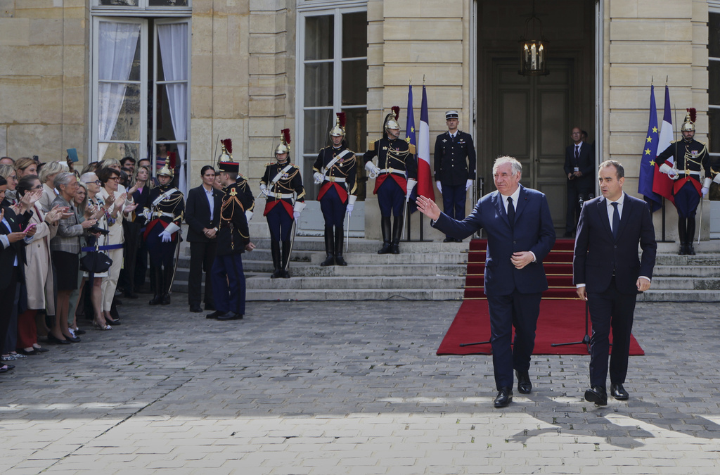 Newly named Prime Minister Sebastien Lecornu, front right, and former French Prime Minister Francois Bayrou, front left, after a handover ceremony at the Prime Minister residence, in Paris, France, Wednesday, Sept. 10, 2025. (Ludovic Marin, Pool Photo via AP)