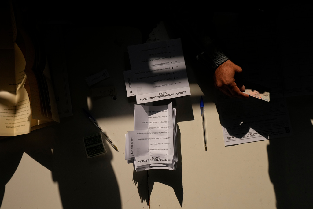 Ballots sit on a table at a polling station during general elections in Santiago, Chile, Sunday, Nov. 16, 2025. (AP Photo/Esteban Felix)