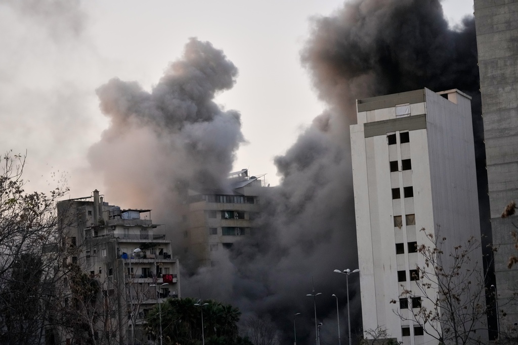 Smoke rises from a building after an Israeli strike in central Beirut, Lebanon, Thursday, March 12, 2026. (AP Photo/Hussein Malla)