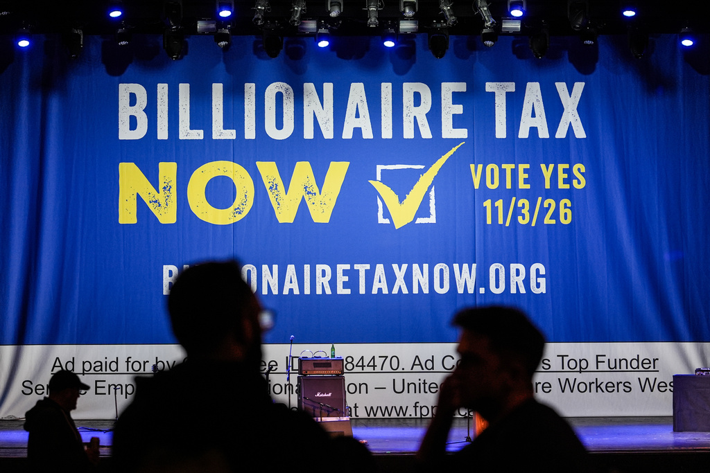 A large banner is seen at a campaign event for a proposed "billionaires tax" in Los Angeles, Wednesday, Feb. 18, 2026. (AP Photo/Jae C. Hong)