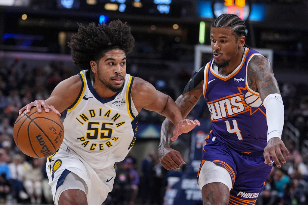 Indiana Pacers guard Ethan Thompson (55) drives on Phoenix Suns guard Jalen Green (4) during the first half of an NBA basketball game in Indianapolis, Thursday, March 12, 2026. (AP Photo/Michael Conroy)