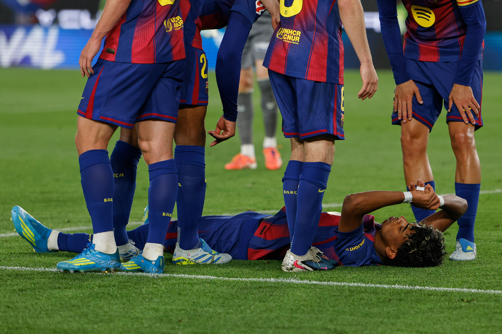 Barcelona's Lamine Yamal lies on the pitch in pain during the Spanish La Liga soccer match between Barcelona and Celta Vigo in Barcelona, Spain, Wednesday, April 22, 2026. (AP Photo/Joan Monfort)
