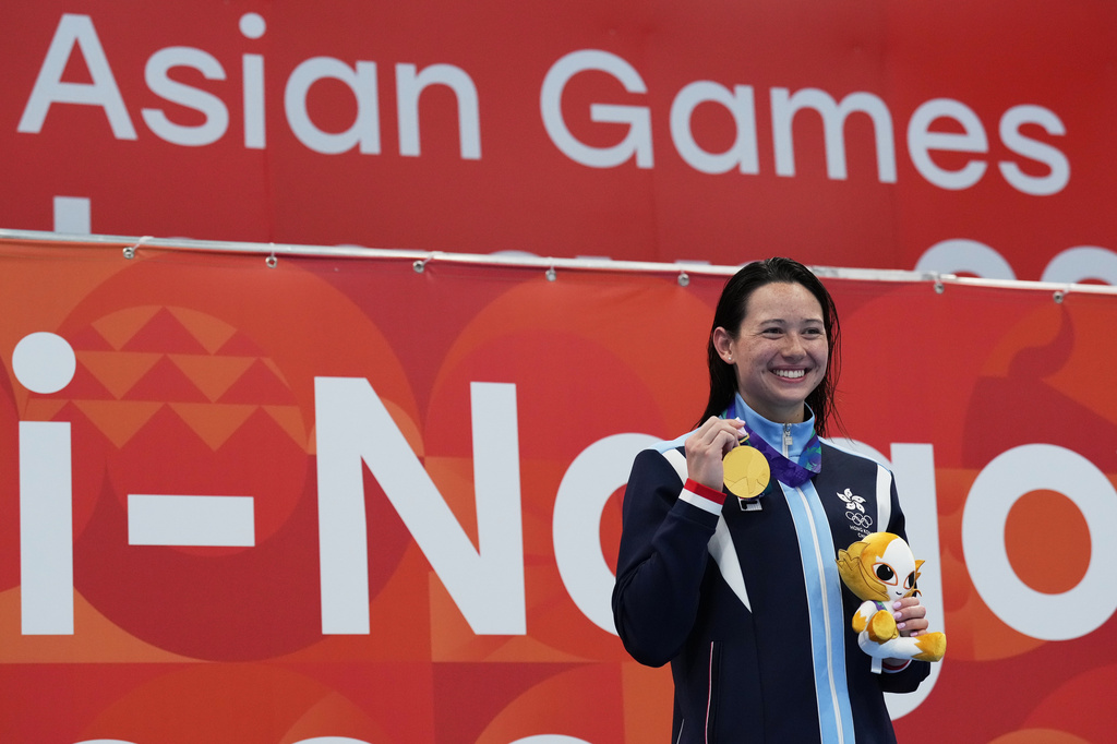 Gold medalist Siobhan Haughey of Hong Kong celebrates on the podium after the women's 200-meter freestyle final in swimming at the Asian Games in Tokyo, Japan, Monday, Sept. 21, 2026. (AP Photo/Hiro Komae)