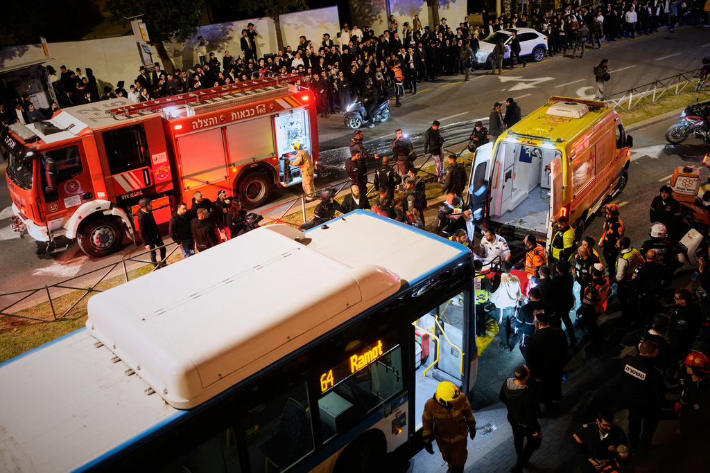 Israeli police inspect a bus following an incident in which it hit ultra-Orthodox Jewish demonstrators blocking a road during a protest against army recruitment in Jerusalem, Tuesday, Jan. 6, 2026. (AP Photo/Ohad Zwigenberg)