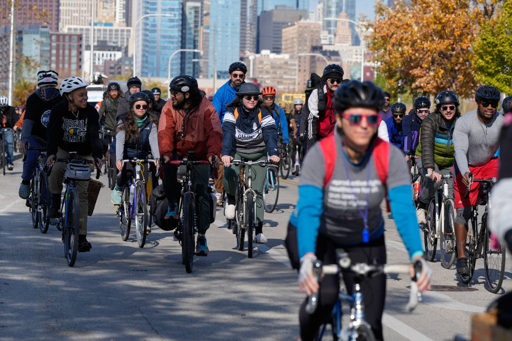 People ride their bicycle during Street Vendor Bike Tour Series, in Chicago, Sunday, Nov. 2, 2025. (AP Photo/Nam Y. Huh)