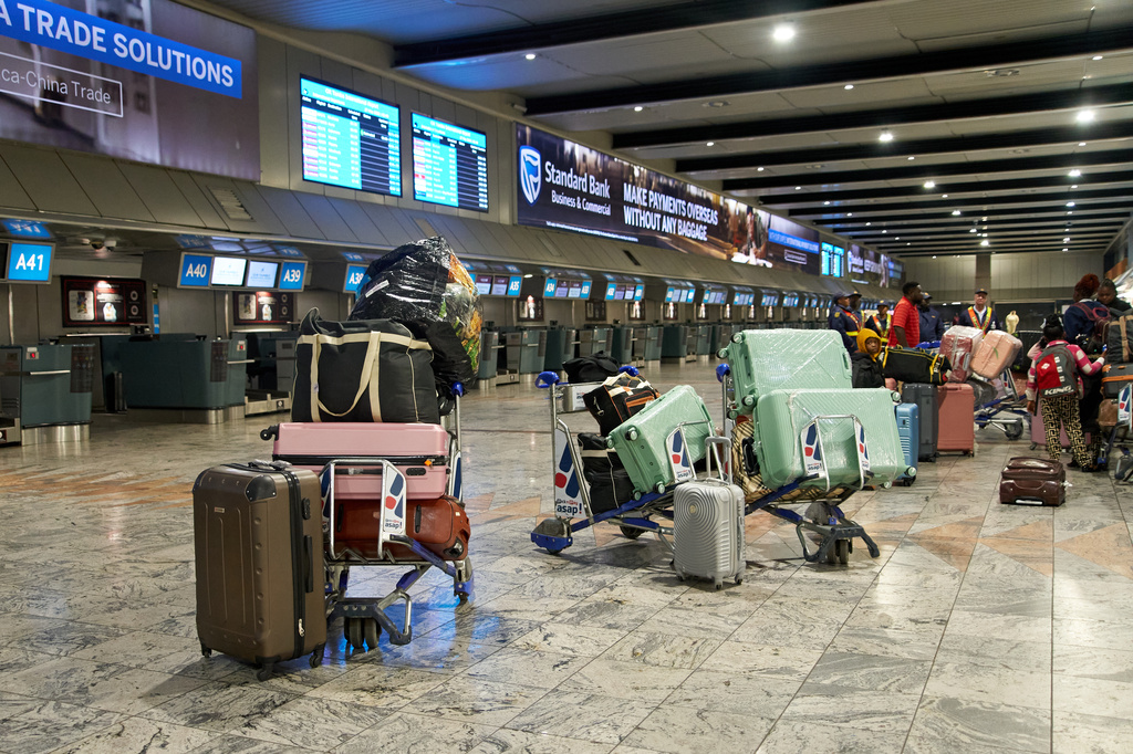 Luggage and personal belongings of Ghanaian nationals awaiting repatriation are lined up near departure counters during preparations for a charter flight from South Africa at O.R. Tambo International Airport in Johannesburg, South Africa, Wednesday, May 27, 2026. (AP Photo/Kayleen Morgan)