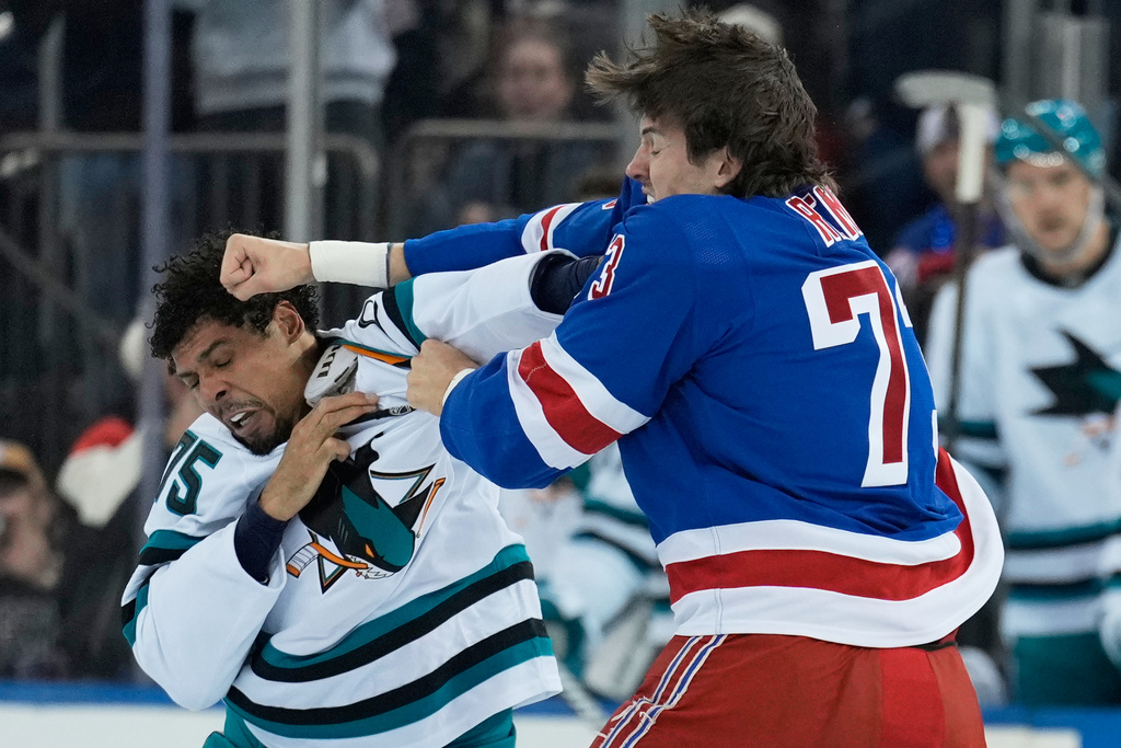 New York Rangers' Matt Rempe, right, fights with San Jose Sharks' Ryan Reaves during the first period of an NHL hockey game in New York, Thursday, Oct. 23, 2025. (AP Photo/Seth Wenig)