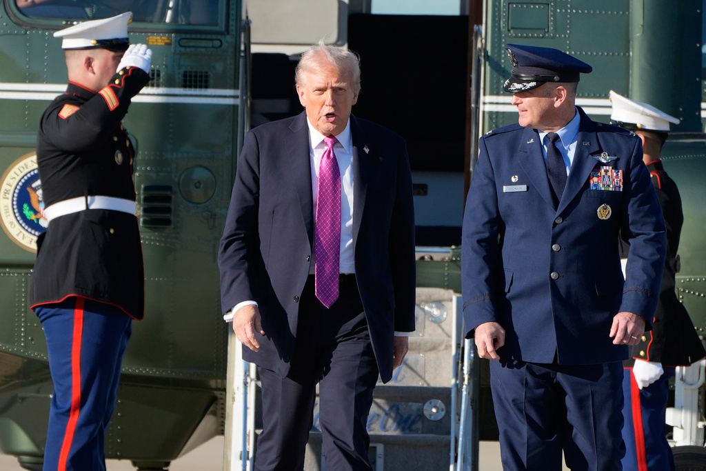 President Donald Trump walks with Air Force Col. Christopher M. Robinson, Commander of the 89th Airlift Wing, from Marine One to board Air Force One, Friday, Oct. 17, 2025, at Joint Base Andrews, Md., for a trip to Florida. (AP Photo/Mark Schiefelbein)