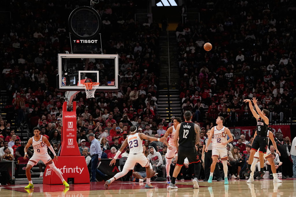 Houston Rockets' Reed Sheppard (15) shoots during the first half of an NBA basketball game against the Phoenix Suns as play continues through a shot clock and scoreboard malfunction Monday, Jan. 5, 2026, in Houston. (AP Photo/David J. Phillip)