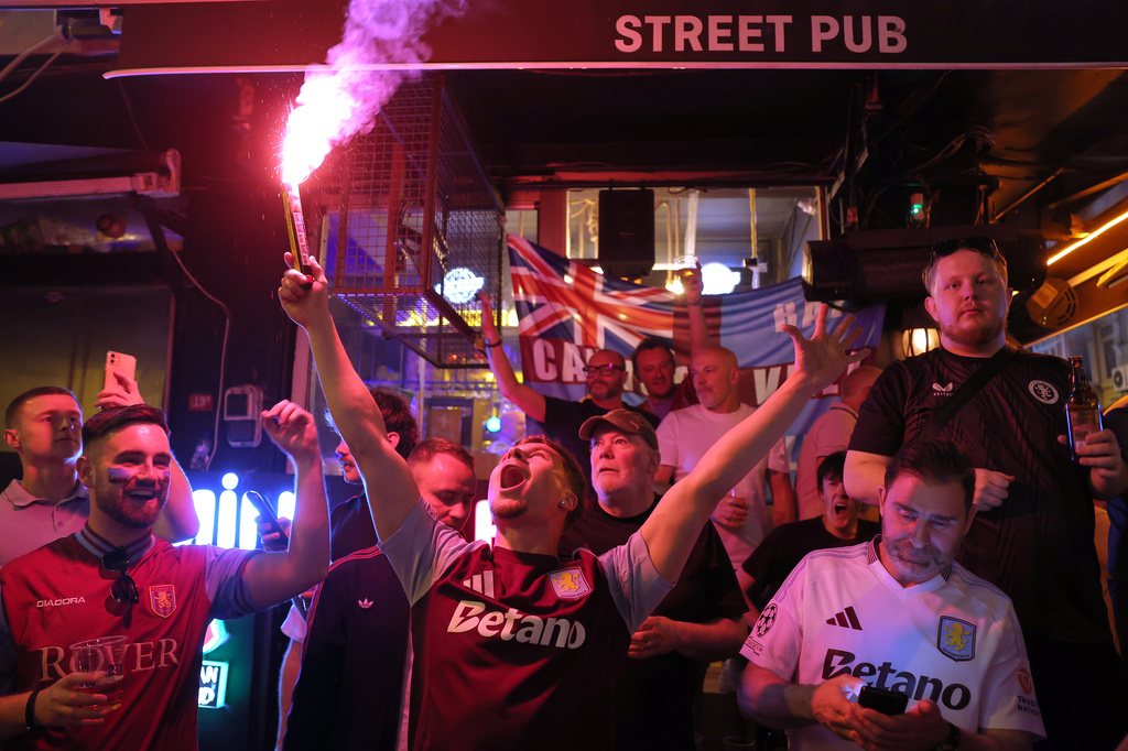 Aston Villa fans light flares and chant as they gather in the streets of Istanbul, Turkey, Tuesday, May 19, 2026, ahead of the Europa League final soccer match between Freiburg and Aston Villa. (AP Photo)