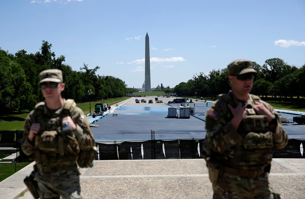As National Guard solider patrol, workers continue to apply a blue protective coating as part of a renovation project to the Lincoln Memorial Reflecting Pool, Friday, May 8, 2026, on the National Mall in Washington. (AP Photo/Rahmat Gul)