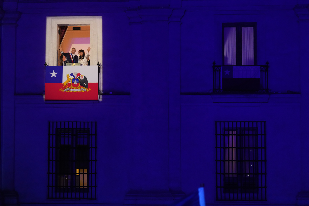 Chile's President Jose Antonio Kast and his wife Maria Pia Adriasola wave to supporters from the balcony of La Moneda presidential palace after his inauguration in Santiago, Chile, Wednesday, March 11, 2026. (AP Photo/Gustavo Garello)