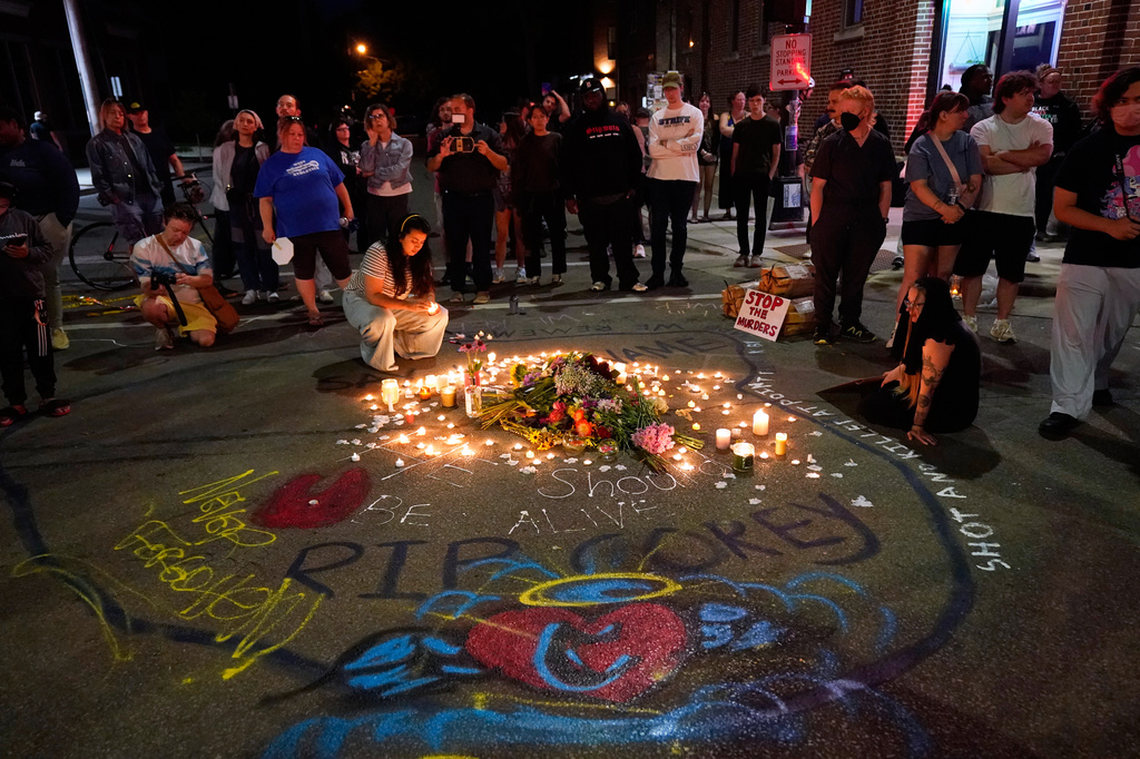 Attendees gather at a candlelight vigil where a Madison police officer shot and killed a man Wednesday, July 22, 2026, in Madison, Wis. (AP Photo/Kayla Wolf)