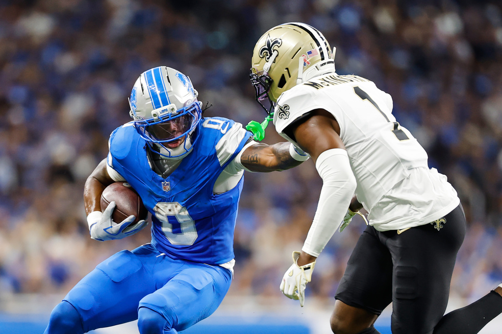 Detroit Lions running back Jahmyr Gibbs (0) carries against New Orleans Saints cornerback Kool-Aid McKinstry (1) in the first half of an NFL football game, Sunday, Sept. 13, 2026, in Detroit. (AP Photo/Rey Del Rio)