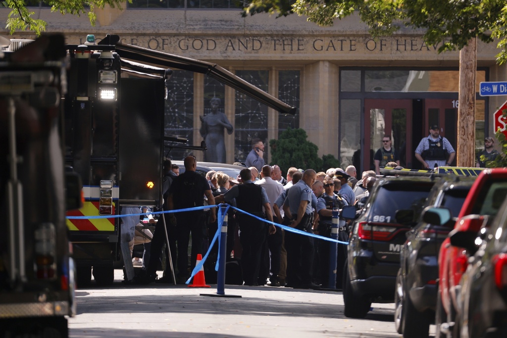 Law enforcement officers gather outside the Annunciation Church in response to a reported mass shooting, Wednesday, Aug. 27, 2025, in Minneapolis. (AP Photo/Bruce Kluckhohn)