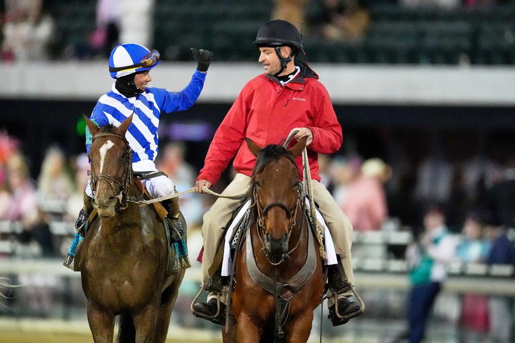 Jockey Jose L. Ortiz celebrates after riding Always a Runner to victory wins the 152nd running of the Kentucky Oaks horse race at Churchill Downs, Friday, May 1, 2026, in Louisville, Ky. (AP Photo/George Walker IV)