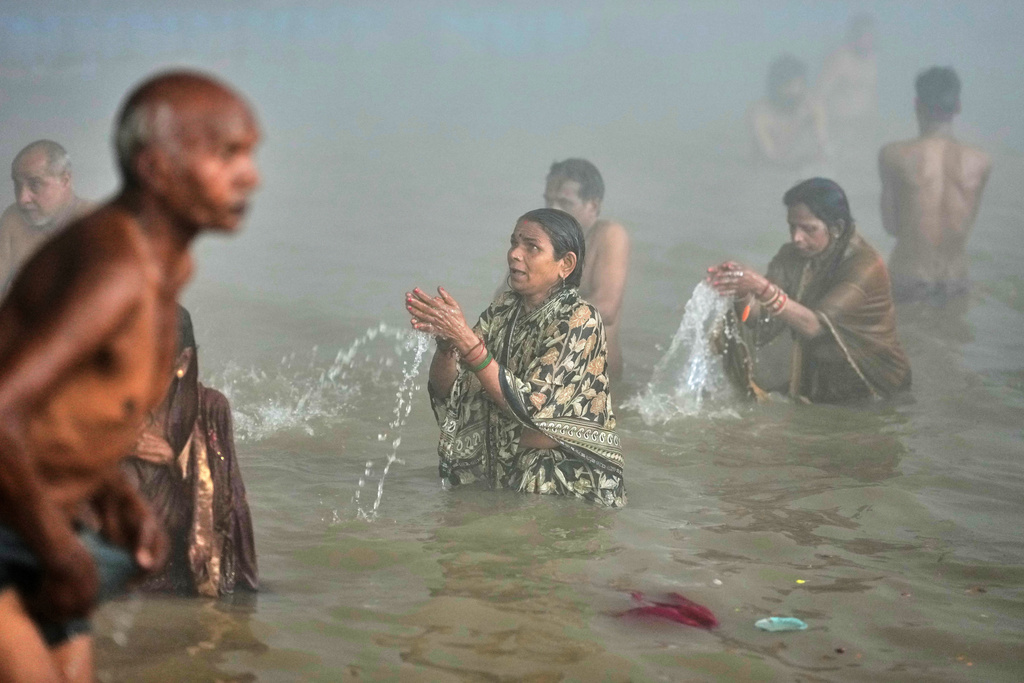 Devotees take a holy dip on Mauni Amavasya, a divine occasion in Hindu religious practice followed for honoring ancestors or forefathers, at the Sangam, the confluence of the Ganges, the Yamuna and the mythical Saraswati rivers, during the annual month long Hindu religious fair "Magh Mela" in Prayagraj, India, Sunday, Jan. 18, 2026. (AP Photo/Rajesh Kumar Singh)