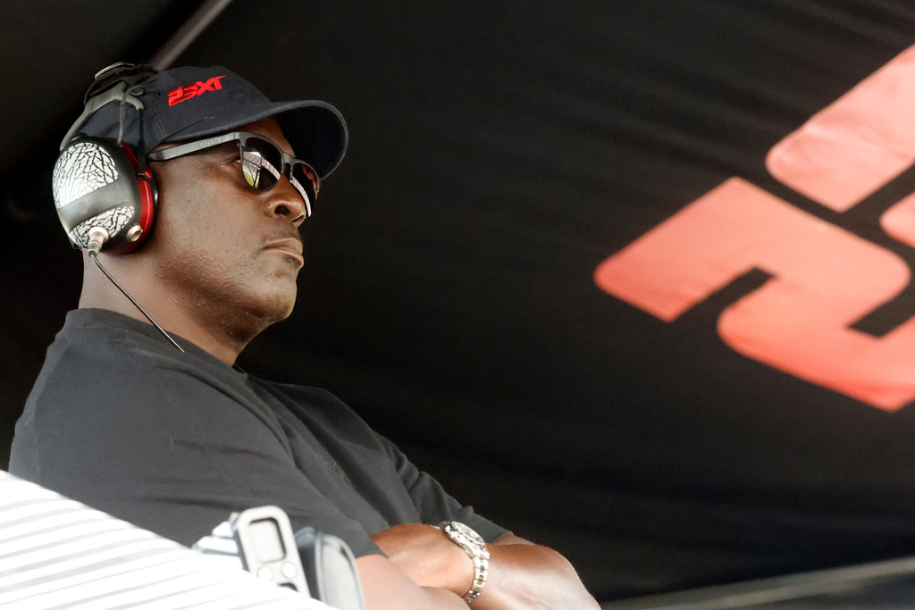 FILE - Michael Jordan, co-owner of 23XI Racing, sits in his pit box during a NASCAR Cup Series auto race at Talladega Superspeedway, Sunday, Oct. 6, 2024, in Talladega, Ala. (AP Photo/ Butch Dill, File)