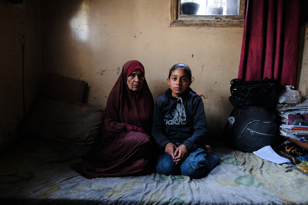 Eleven-year-old Ghazal al-Kibritti, who lost her parents and three siblings in an Israeli airstrike, poses with her grandmother, Huda al-Salti, at the Gaza City home where she now lives with her grandparents, Sunday, April 26, 2026. (AP Photo/Jehad Alshrafi)