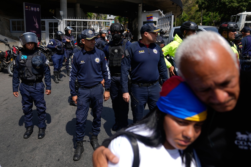 Police standby to keep people from advancing closer to the Helicoide detention center after the crowd attended a prayer for freedom of political prisoners, peace and reconciliation in Caracas, Venezuela, Saturday, Feb. 7, 2026. (AP Photo/Ariana Cubillos)