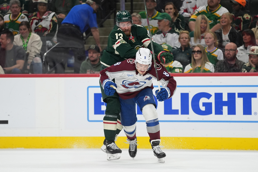 Minnesota Wild center Yakov Trenin (13) pushes Colorado Avalanche defenseman Cale Makar (8) during the first period of Game 4 in a second-round NHL hockey Stanley Cup playoff series Monday, May 11, 2026, in St. Paul, Minn. (AP Photo/Abbie Parr)