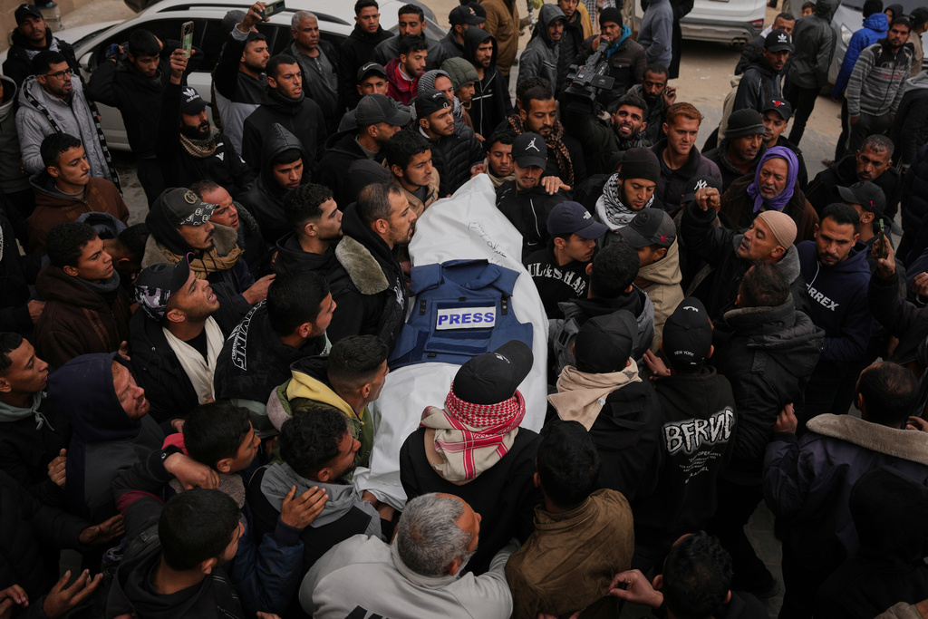 Mourners carry the body of Anas Ghoneim, one of the three Palestinian journalists who were killed in an Israeli strike on an Egyptian committee's vehicle, during his funeral in Khan Younis, southern Gaza Strip, Thursday, Jan. 22, 2026. (AP Photo/Abdel Kareem Hana)