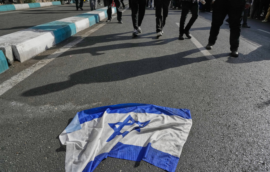 An Israeli flag is placed on the ground during an annual rally in front of the former U.S. Embassy in Tehran, celebrating the anniversary of the 1979 takeover of the embassy, Iran, Tuesday, Nov. 4, 2025. (AP Photo/Vahid Salemi)