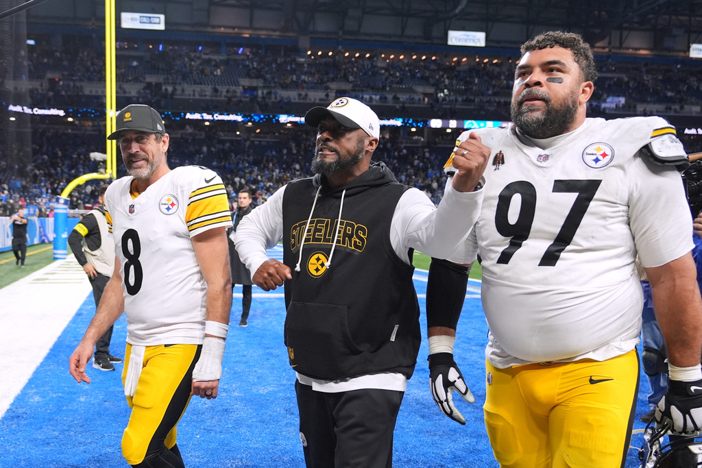 Pittsburgh Steelers' Aaron Rodgers, from left, Mike Tomlin and Cameron Heyward walk off the field after Pittsburgh won an NFL football game against the Detroit Lions, Sunday, Dec. 21, 2025, in Detroit. (AP Photo/Ryan Sun)