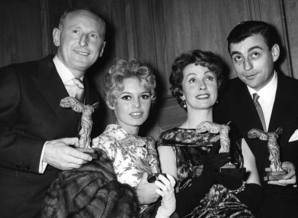 FILE - French screen stars from left, Andre Bourvil, Brigitte Bardot, Danielle Darrieux and Francois Perier pose for a photo with their French motion picture award statuettes, in Paris France, Dec. 3, 1963. (AP Photo/Jacques Marqueton, File)