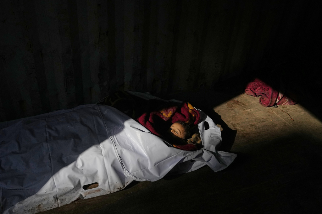 The body of 4-year-old Palestinian, Ahmed Weshah lies next to that of his mother Afaf Abu Jahjouh, 28, who were both killed in an Israeli military strike on Sunday, before their funeral at Awda Hospital, in Nuseirat, in the central Gaza Strip, Monday, Oct. 20, 2025. (AP Photo/Abdel Kareem Hana)