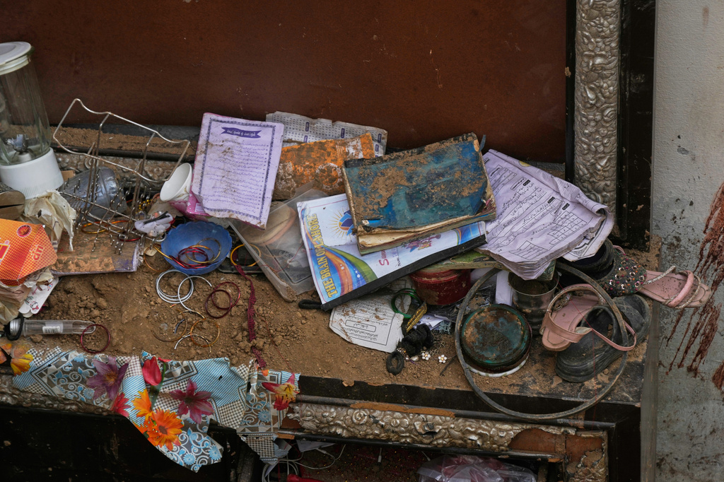 Books, shoes and other stuff of victim children are seen at the site of Tuesday's roof collapse at a tutoring center roof, on the outskirts of Lahore, Pakistan, Wednesday, July 1, 2026. (AP Photo/K.M. Chaudary)