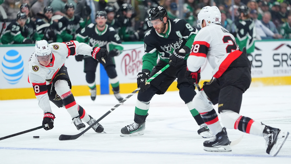 Dallas Stars center Tyler Seguin (91) tries to move the puck past Ottawa Senators center Tim Stützle (18) and right wing Claude Giroux (28) during the first period of an NHL hockey game, Sunday, Nov. 30, 2025, in Dallas. (AP Photo/LM Otero)