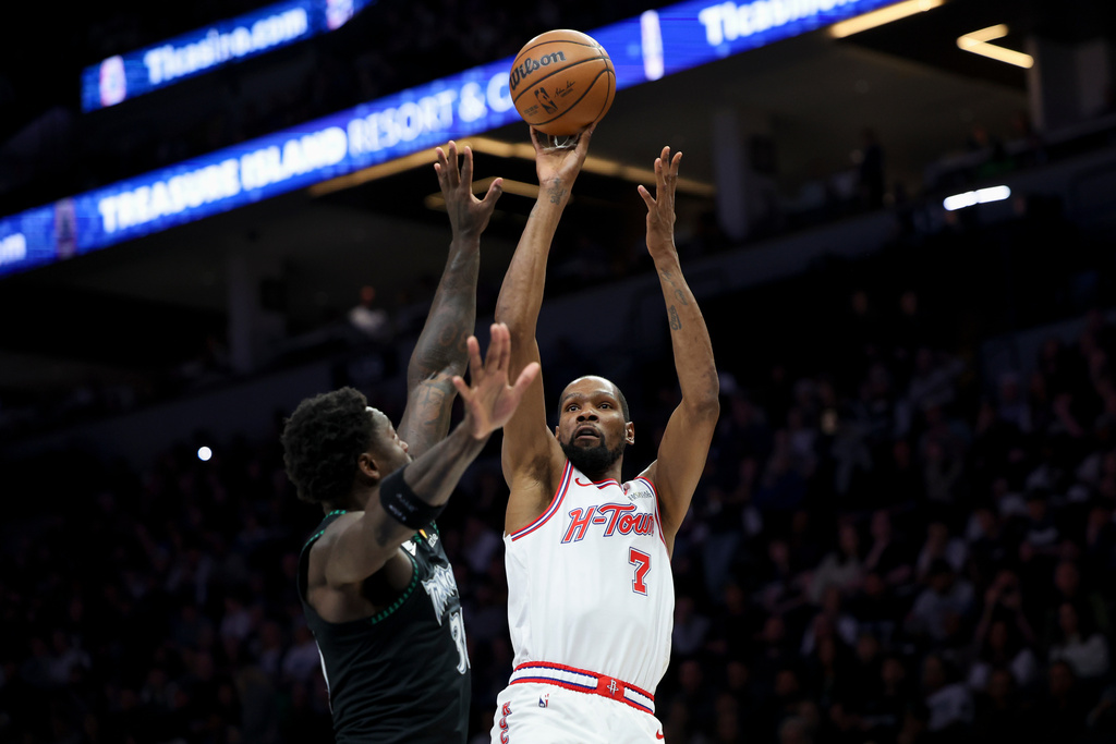 Houston Rockets forward Kevin Durant (7) shoots against Minnesota Timberwolves forward Julius Randle (30) during the first half of an NBA basketball game, Wednesday, March 25, 2026, in Minneapolis. (AP Photo/Ellen Schmidt)