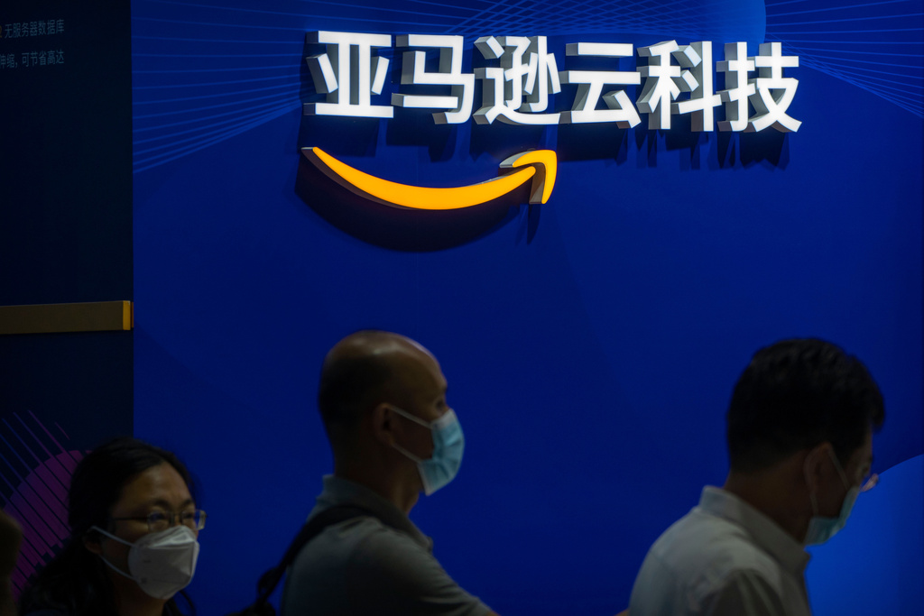 FILE - Vistiors stand in line at a booth for Amazon cloud computing services at the China International Fair for Trade in Services (CIFTIS) in Beijing, Friday, Sept. 2, 2022. (AP Photo/Mark Schiefelbein, File)