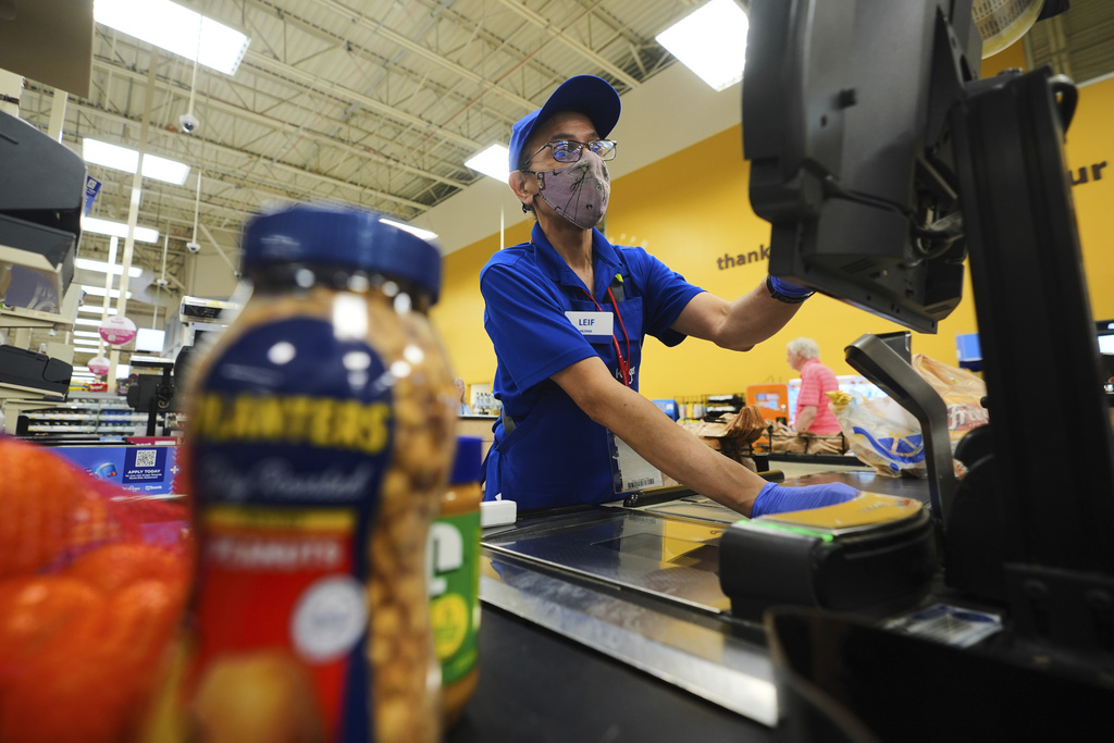 A cashier rings up groceries in Dallas, Thursday, Aug. 28, 2025. (AP Photo/LM Otero)