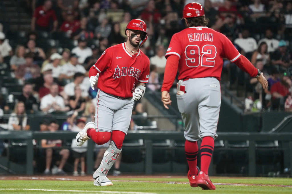 Los Angeles Angels' Zach Neto celebrates with first base coach Adam Eaton (92) after hitting a solo home run against the Arizona Diamondbacks in the third inning of a baseball game, Tuesday, June 16, 2026, in Phoenix. (AP Photo/Rick Scuteri)