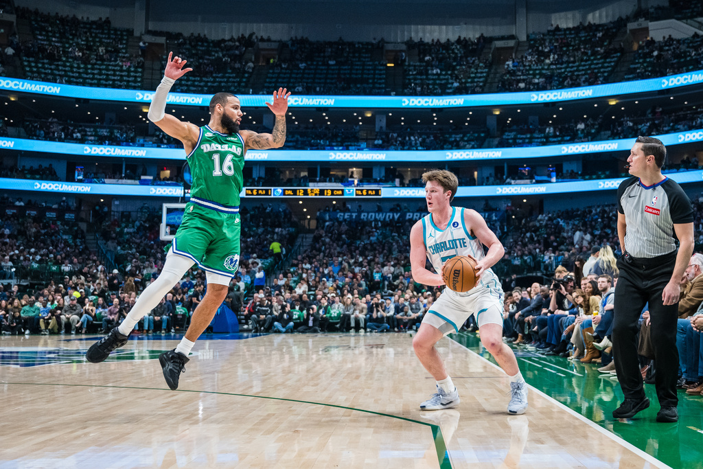 Charlotte Hornets guard Kon Knueppel looks to shoot the ball against Dallas Mavericks forward Caleb Martin (16) during an NBA basketball game, Thursday, Jan. 29, 2026, in Dallas. (AP Photo/Jessica Tobias)
