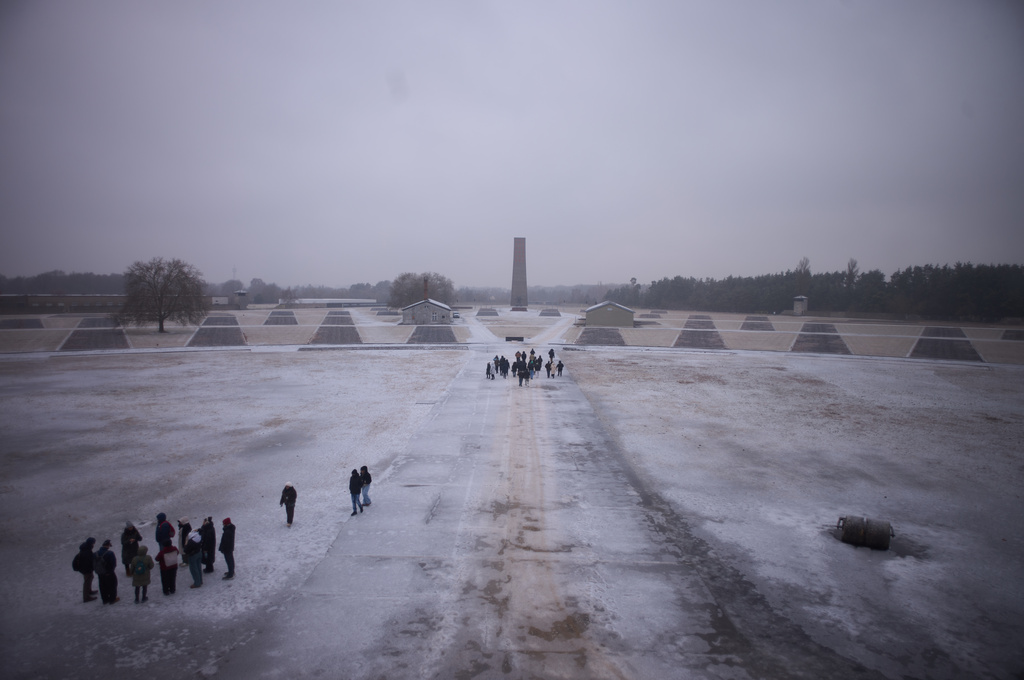 Visitors take a tour though the Nazi Concentration Camp Sachsenhausen on the eve on the International Holocaust Memorial Day in Oranienburg, Germany, Monday, Jan. 26, 2026. (AP Photo/Markus Schreiber)