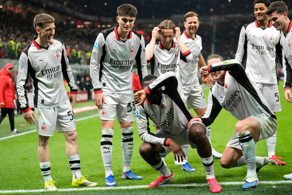AC Milan's Youssouf Fofana, bottom center, celebrates scoring his side's 3rd goal with teammates during the Serie A soccer match between AC Milan and Torino, in Milan, Italy, Saturday, March 21, 2026. (AP Photo/Luca Bruno)