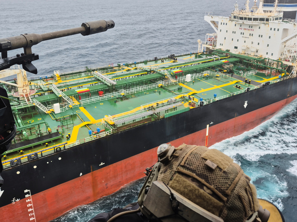 In this handout photo provided by the French Army, a French army NH90 helicopter flies over the oil tanker Tagor, which is under international sanctions and was traveling from Russia in the Atlantic Sea, Sunday, May 31, 2026. (French Army via AP)