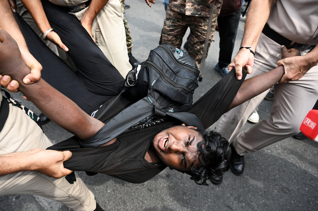 Security personnel detain a protester during a youth demonstration demanding the resignation of the country's election chief Gyanesh Kumar, in New Delhi, India, Sunday, Oct. 11, 2026. (AP Photo/Vipin)