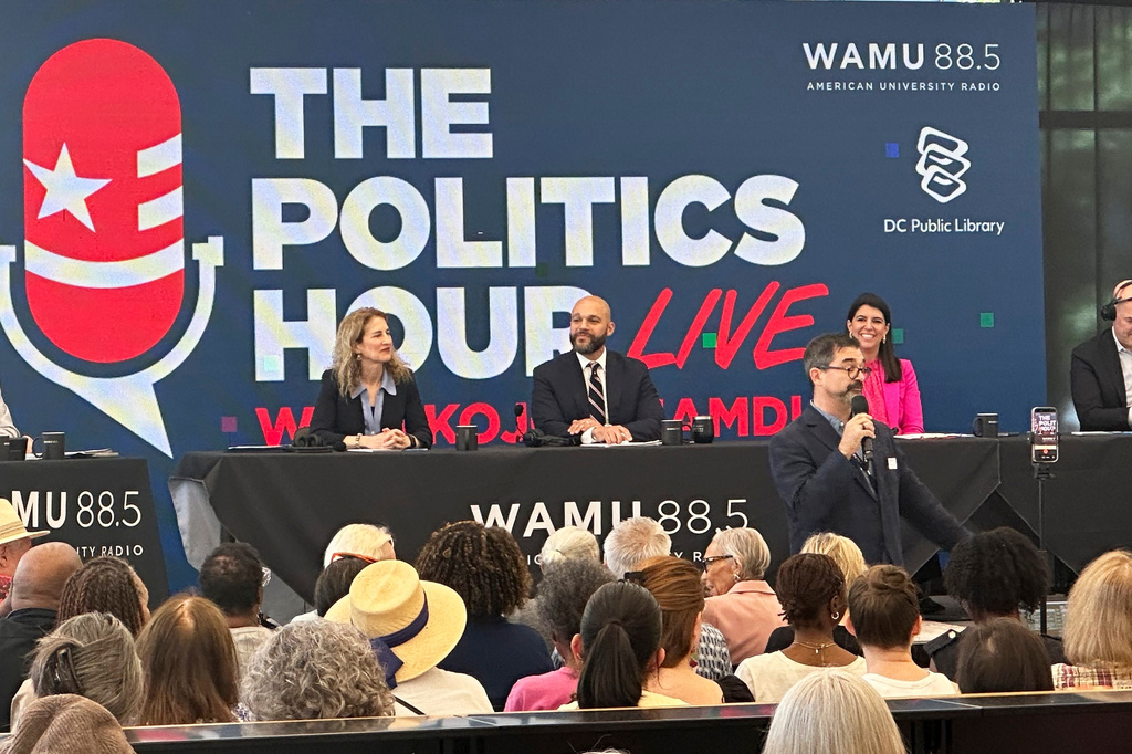 Robert White Jr., center, and Brooke Pinto, right, candidates for Washington D.C. delegate, participate in a forum at the Martin Luther King Jr. Memorial Library, Friday, May 29, 2026. (AP Photo/Gary Fields)