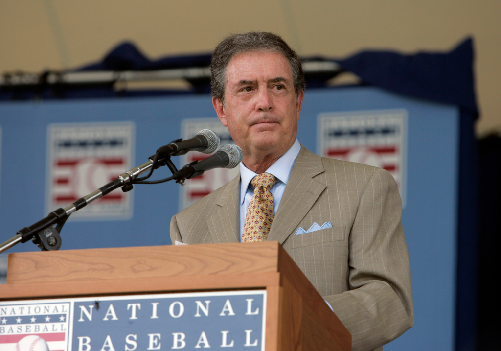 FILE - Kansas City Royals broadcaster Denny Matthews speaks after receiving the Ford C. Frick Award for broadcasting excellence during the National Baseball Hall of Fame Induction Ceremony in Cooperstown, N.Y. Sunday, July 29, 2007. (AP Photo/Mike Groll, File)
